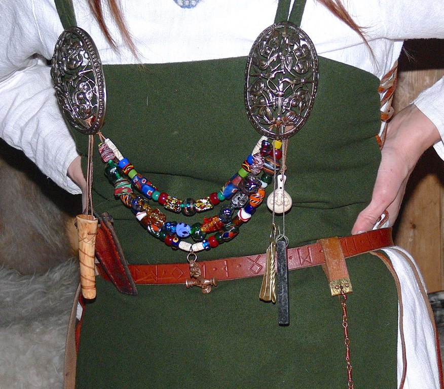 Typical jewellery worn by women of the Karls and Jarls: ornamented silver brooches, coloured glass-beads and amulets